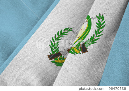 Guatemala flag with big folds waving close up under the studio light indoors. The official symbols and colors in banner 96470586