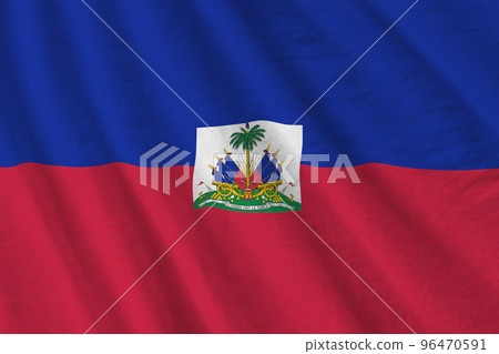 Haiti flag with big folds waving close up under the studio light indoors. The official symbols and colors in banner 96470591