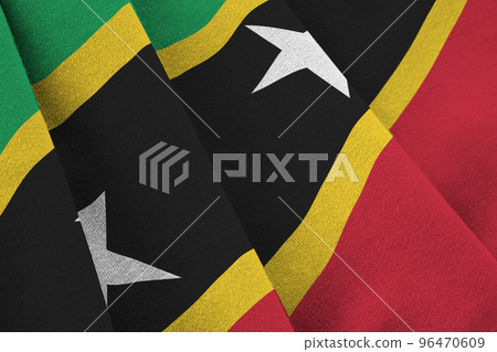 Saint Kitts and Nevis flag with big folds waving close up under the studio light indoors. The official symbols and colors in banner 96470609