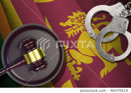 Sri Lanka flag with judge mallet and handcuffs in dark room. Concept of criminal and punishment, background for judgement topics Sri Lanka flag with judge mallet and handcuffs in dark room. Concept of criminal and punishment, background for judgement topics 96470619