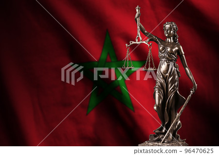 Morocco flag with statue of lady justice and judicial scales in dark room. Concept of judgement and punishment 96470625