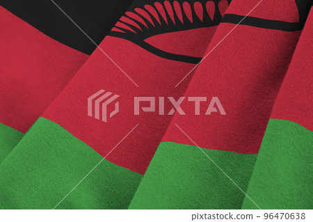 Malawi flag with big folds waving close up under the studio light indoors. The official symbols and colors in banner 96470638