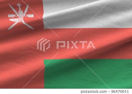 Oman flag with big folds waving close up under the studio light indoors. The official symbols and colors in banner 96470651