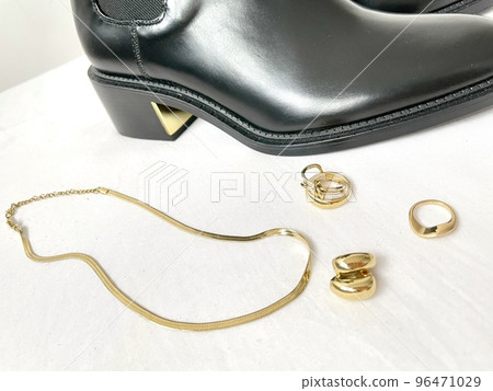 Black boots and various gold accessories Black boots and various gold accessories 96471029