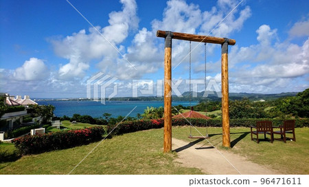 A swing on a hill overlooking the sea 96471611