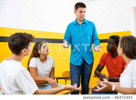 Group of young students studying in university with male tutor 96472485