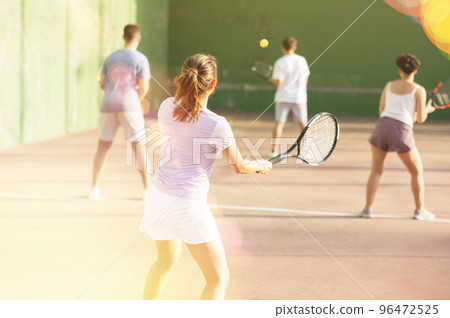 Woman playing frontenis on outdoor pelota court 96472525