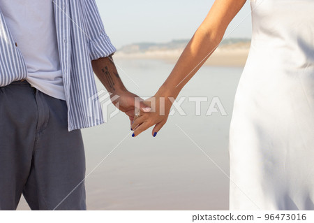 Close-up of happy couple holding hands Close-up of happy couple holding hands 96473016