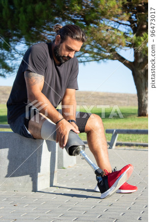 Portrait of man with disability preparing for training outdoors Portrait of man with disability preparing for training outdoors 96473017