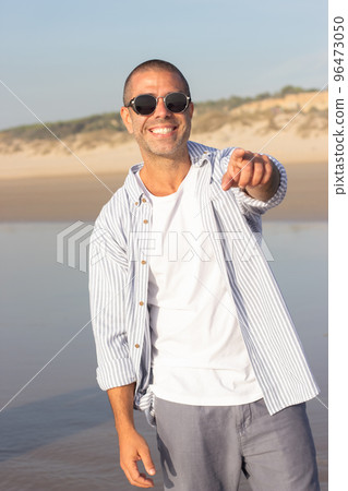 Portrait of fashionable young man on beach 96473050