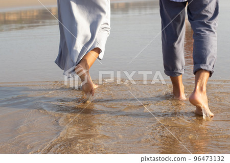 Close-up of male and female bare feet Close-up of male and female bare feet 96473132