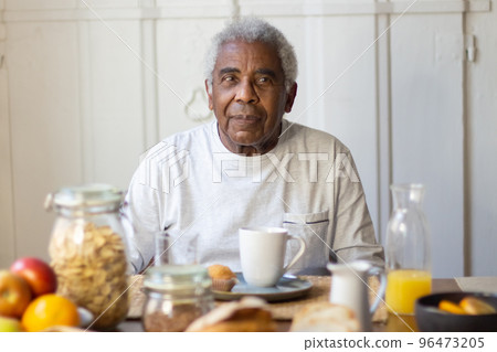 Portrait of senior man enjoying morning tea in kitchen 96473205