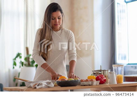 Portrait of young woman preparing her favorite pie 96473414