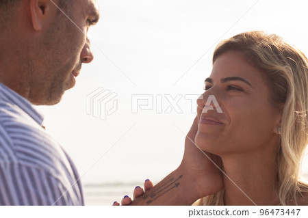 Content couple walking on beach 96473447