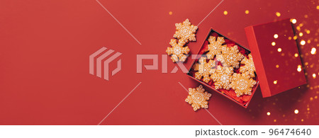 Christmas gingerbread cookies red box on a red festive background with sparkles and serpentine 96474640