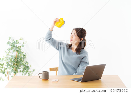 Woman holding a wallet White background 96475922