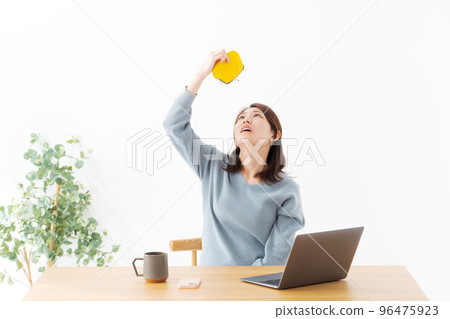 Woman holding a wallet White background Woman holding a wallet White background 96475923