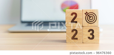 2023 Year block with dartboard icon against computer laptop background. Goal, Target, Resolution, strategy, plan, Action, mission, motivation, and New Year start concepts 96476360