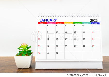 The January 2023 Monthly desk calendar for 2023 year with small plant on wooden table. The January 2023 Monthly desk calendar for 2023 year with small plant on wooden table. 96476771