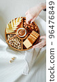 Wooden round menagerie in women's hands 96476849
