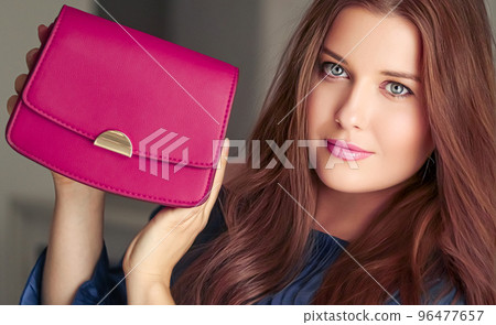 Fashion and accessories, happy beautiful woman holding small pink handbag with golden details as stylish accessory and luxury shopping concept 96477657