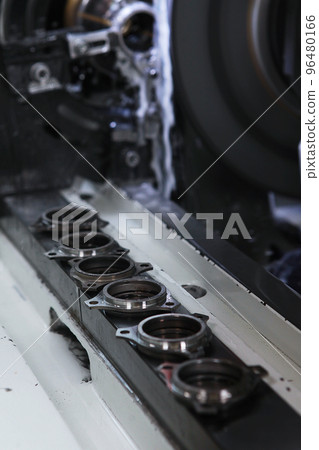 Manufacture of bearings. Details of new bearings on the machine.Concept of the industrial industry. Selective focus.Vertical photo. 96480166