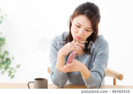 Woman suffering from hair care Woman suffering from hair care 96480426