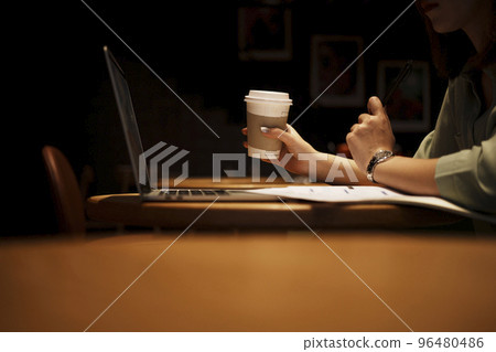 Close up hand asian woman holding pen in casual clothes working in cafe with laptop. 96480486