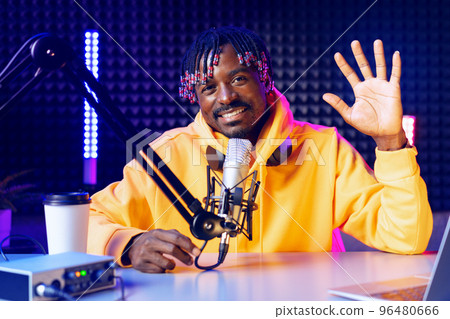 Happy young african man audio blogger broadcasting at studio 96480666