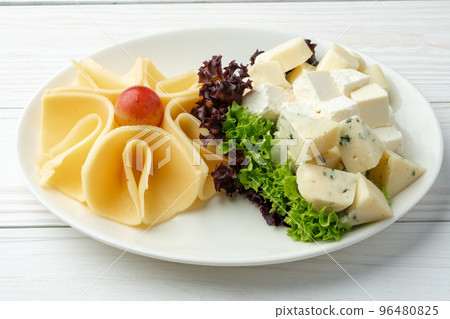 Assortment of cheese on a white plate Assortment of cheese on a white plate 96480825