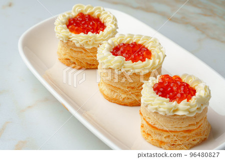 Red caviar in tartlets on white plate Red caviar in tartlets on white plate 96480827
