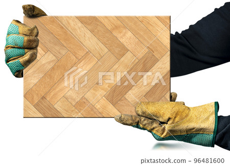 Gloved Hands Holding a Herringbone Wood Parquet Sample Isolated on White 96481600