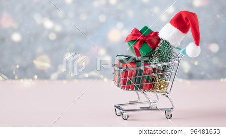 Shopping cart with Christmas presents and Christmas tree. Christmas and New year shopping concept. 96481653