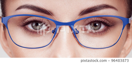Woman with long eyelashes in eyeglasses 96483873
