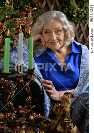 portrait of an old woman on the background of a new year's decor 96484221
