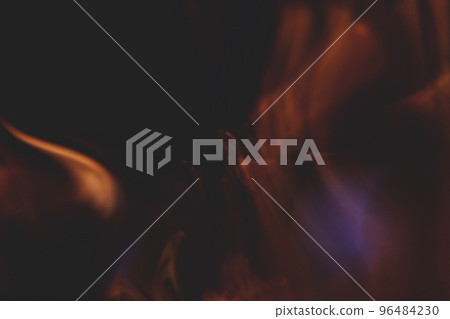 Light flare overlay. Defocused glow. Old film effect. Blur orange blue color smeared flecks texture on dark black abstract copy space background. 96484230