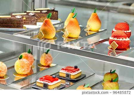Colorful showcase of cafe with fresh sweet cakes and fruit shaped pastries 96485872