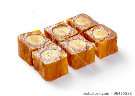 Sweet sushi rolls with chocolate cream cheese and banana in thin pancake Sweet sushi rolls with chocolate cream cheese and banana in thin pancake 96485888