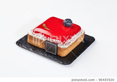 Small cheesecake on shortcrust pastry with berry jelly, coconut flakes, ripe blueberry and chocolate 96485920