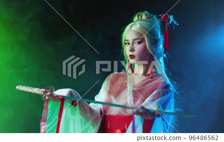 beautiful girl in a geisha costume with a katana in neon light 96486562