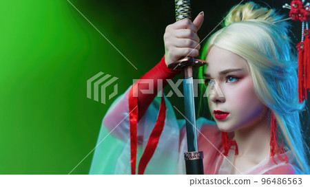 beautiful girl in a geisha costume with a katana in neon light beautiful girl in a geisha costume with a katana in neon light 96486563
