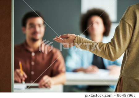Selective focus on hand of mature teacher or speaker 96487965