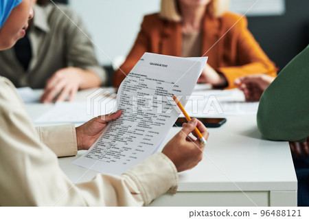 Selective focus on hands of Muslim female student with grammar test Selective focus on hands of Muslim female student with grammar test 96488121