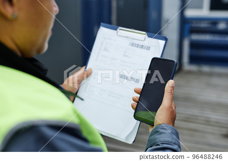 Copy space of unrecognizable worker holding clipboard Copy space of unrecognizable worker holding clipboard 96488246