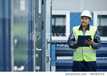 Smiling female worker at shipping docks 96488250