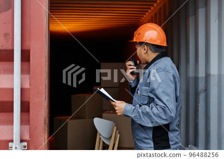 Female worker at shipping dock Female worker at shipping dock 96488256