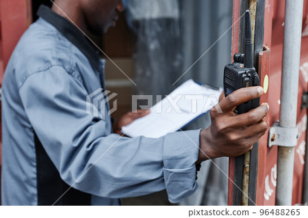 Close up of male worker opening container door 96488265
