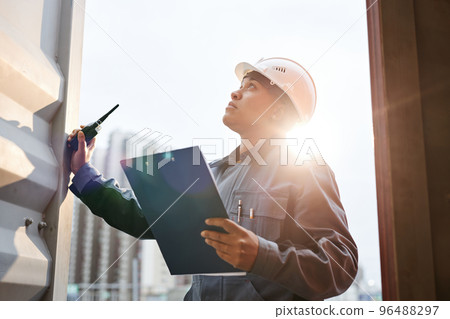 Dock worker in sunlight 96488297