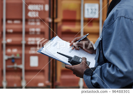 Close up of male worker writing on clipboard 96488301