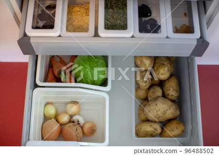 Storing vegetables in the kitchen. Storing vegetables in the kitchen. 96488502
